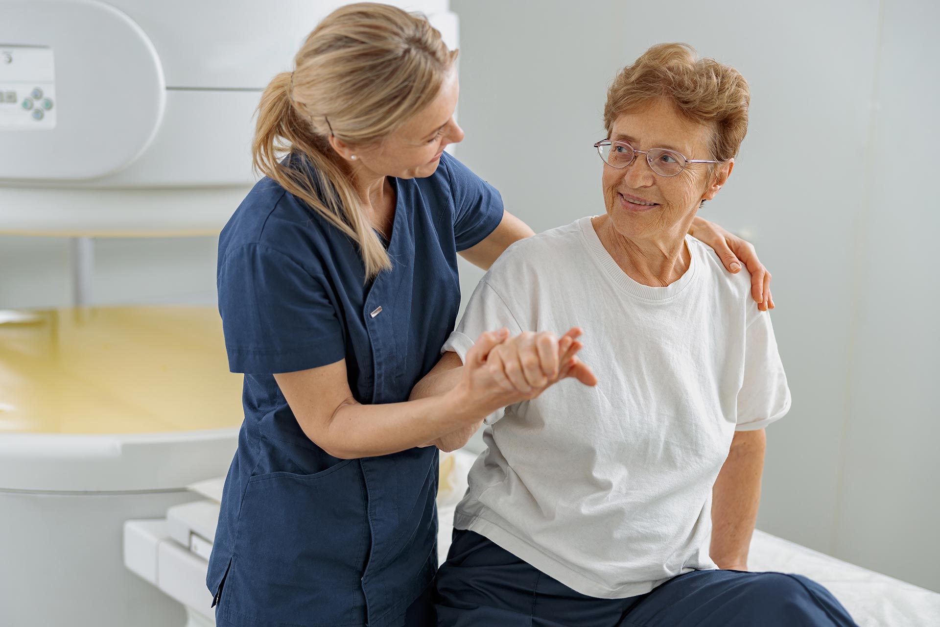 doctor help older female patient to sit after Physical Therapy evaluation