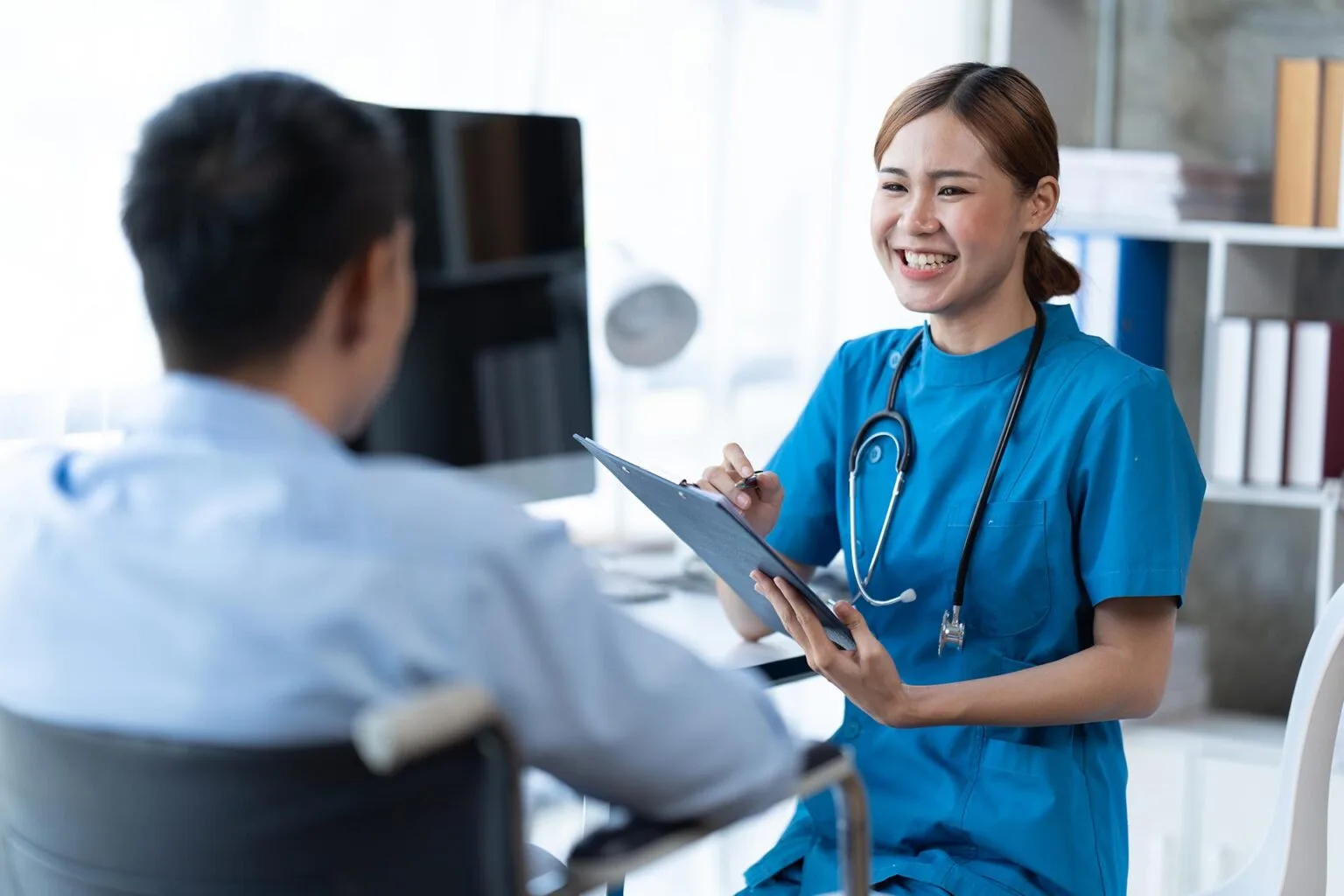physical therapist helping patient