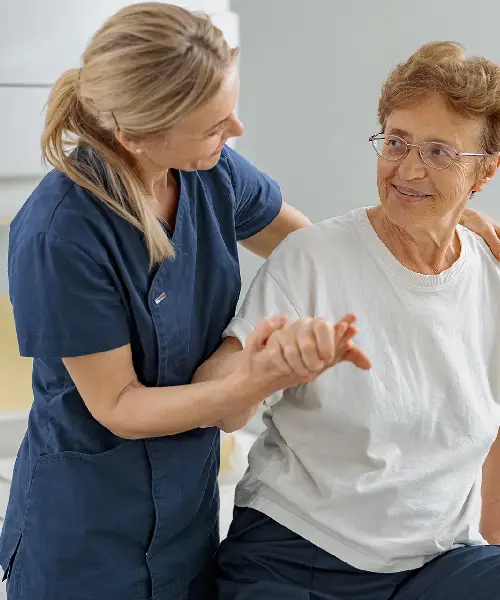 doctor help older female patient to sit after Physical Therapy evaluation